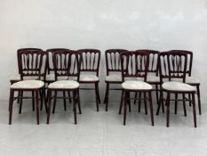 A set of ten vintage stained teak Cheltenham dining chairs each having a curved and spindled back