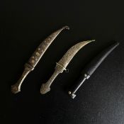 Three Eastern knives to include a 19th century Persian white metal Kandjar or Jambiya dagger