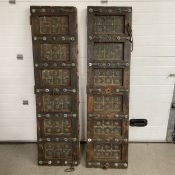 A pair of Indian painted and metal studded hardwood panelled doors. H.184 W.51cm
