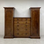 A mid 19th century mahogany compactum wardrobe with central chest of drawers flanked by hanging