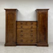 A mid 19th century mahogany compactum wardrobe with central chest of drawers flanked by hanging