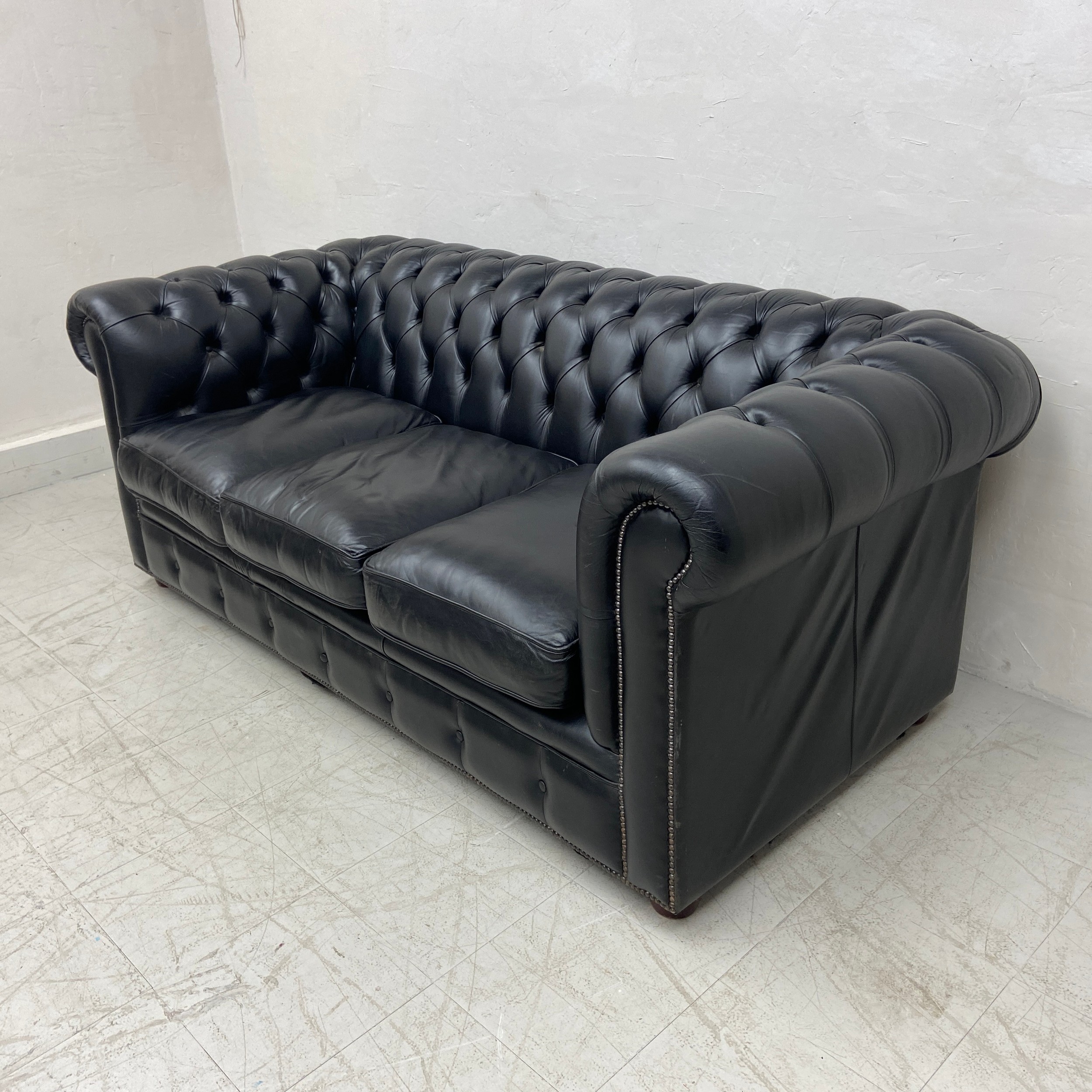 A black leather three seater Chesterfield sofa having a scrolled deep button back and arms over a - Image 2 of 4