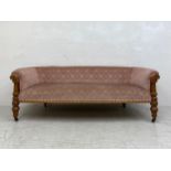 A mid 19th century oak sofa re-upholstered in foliate dusty pink raised on turned and carved
