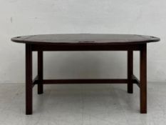 A large 19th century mahogany butlers tray table in two parts having an oval top with hinged sides