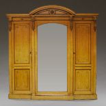 A late 19th century compactum wardrobe stamped Holland & Son with mirrored central hanging section