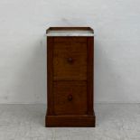 A Louis Philippe flame mahogany bedside cabinet with marble top above a faux twin drawer door