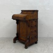 A 19th century burr walnut piano top Davenport having a thumb moulded top hinged to reveal a