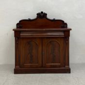 A 19th century mahogany chiffonier or side cabinet with carved arched back and flame mahogany
