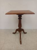 A 19th century mahogany occasional table having a square thumb-moulded top raised on a turned