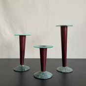 A set of three 1980s Memphis design candlesticks in plexi-glass, stained wood and marble. H.24.5cm
