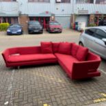 A contemporary six seater Arne corner sofa in two parts having an angular back and arms with open