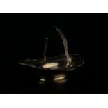 A hallmarked silver swing handled basket with pierced and engraved border on oval foot, Sheffield