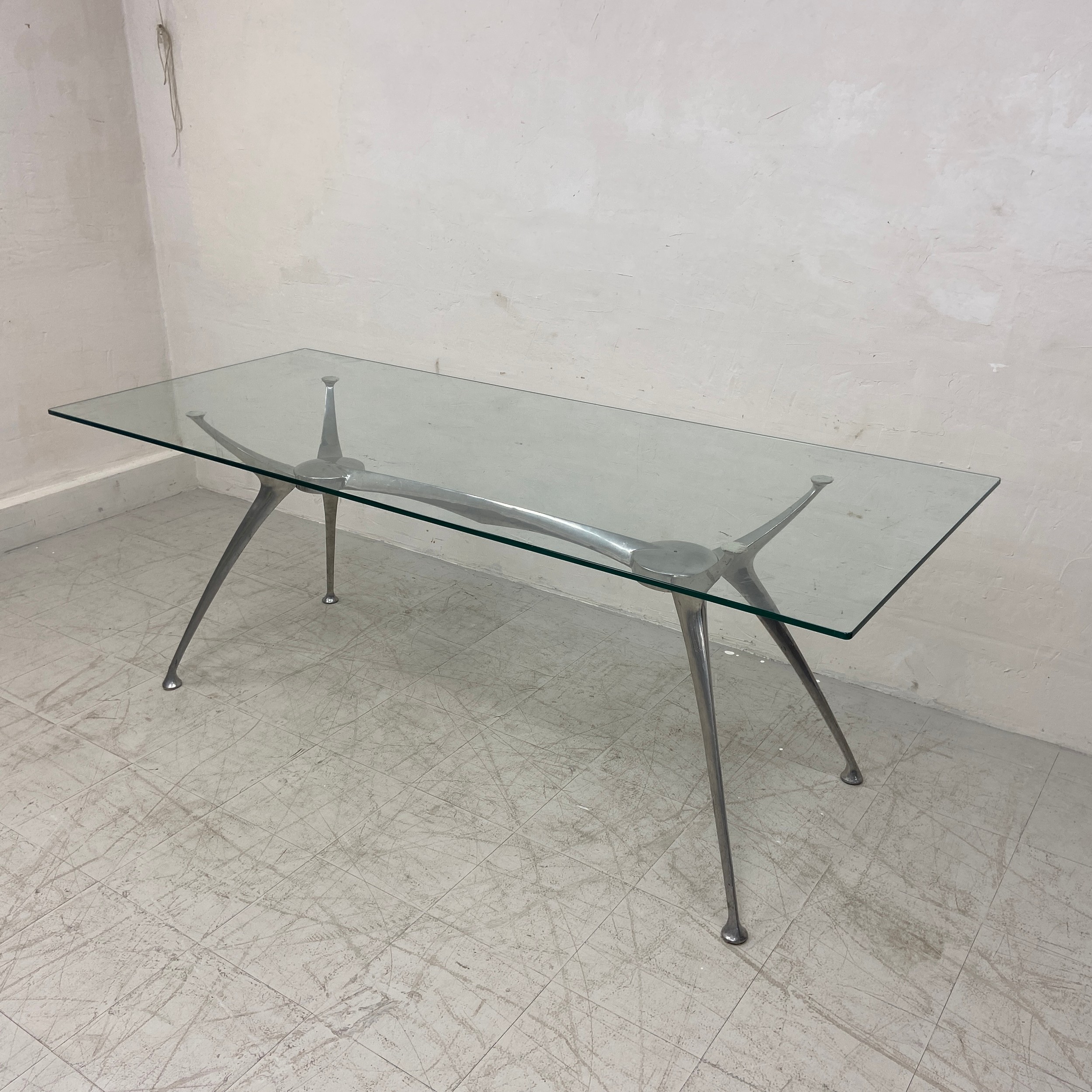 A contemporary dining table in the style of Philippe Starck with plate glass top on an aluminium - Image 2 of 3