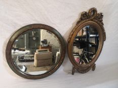 Two wall mirrors to include one 19th century with an oval bevelled plate in a painted and moulded