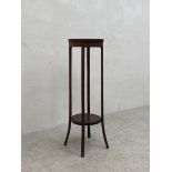 A C.1900 mahogany plant stand having a circular satinwood inlaid top raised on four flat splayed