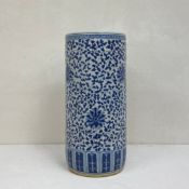 A Chinese blue and white ceramic umbrella or stick stand of cylindrical form with all-over scrolling