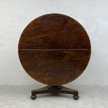 A William IV rosewood tilt top table dining table on triform acanthus carved base. H.73 Dia.128cm (