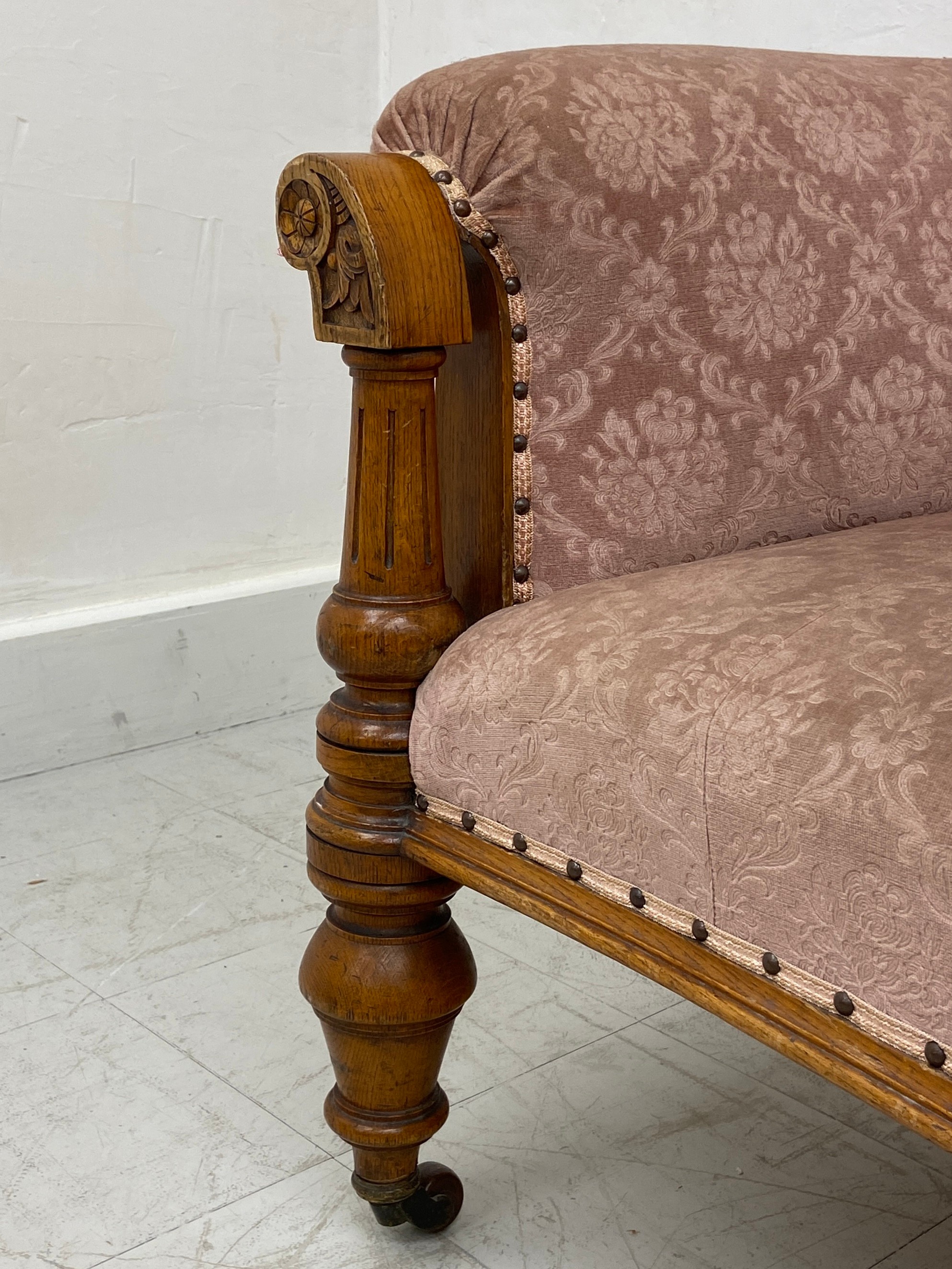 A mid 19th century oak sofa re-upholstered in foliate dusty pink raised on turned and carved - Image 5 of 6