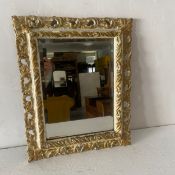 A 19th century gilt and painted Florentine style wall mirror having its original bevelled plate in a