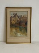An early 20th century watercolour depicting a bridge over a canal in a village setting by John