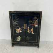 A contemporary Chinese lacquered cabinet having a rectangular hand painted top over a pair of