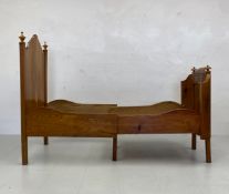 A 19th century figured light elm single or child's bedstead with sliding adjustable action for
