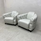 A pair of contemporary Italian white leather armchairs each having a curved back and deep buttoned
