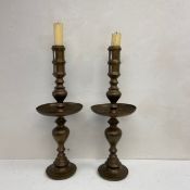 A pair of large 20th century North African brass candlesticks each having a turned and engraved stem