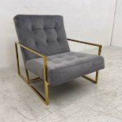 A contemporary armchair having a grey velour upholstered square buttoned back and seat raised on a