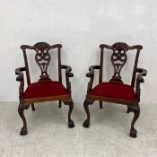 A pair of vintage mahogany Chippendale style armchairs of generous size each having a shaped and