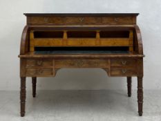 A 19th century French Empire mahogany cylinder bureau with slate top above a well fitted bird's