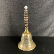 A large C.1900 handbell having a spherical white glazed porcelain finial on a turned ebony handle