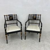 A pair of contemporary Regency style elbow chairs each having a shaped gilt and lacquered back and