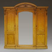 A late 19th century compactum wardrobe stamped Holland & Son with mirrored central hanging section