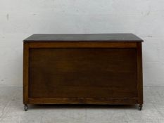 A mid century oak trunk on casters. H.52 W.92 D.47cm