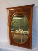 A late 19th century carved walnut wall mirror with bevelled plate. 52x79cm