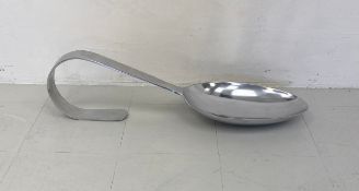 A very large decorative aluminium tasting spoon. L.88cm