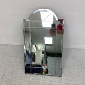 A vintage Art Deco style mirror having a shaped bevelled plate with simple engraved borders. H.66