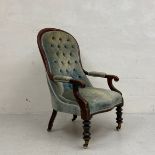 A 19th century mahogany open library armchair having a curved top-rail and deep buttoned back with