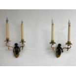A pair of wall sconces in the French 19th century style each having a central patinated bronze