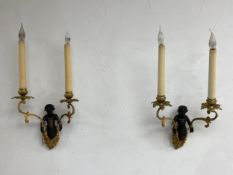 A pair of wall sconces in the French 19th century style each having a central patinated bronze