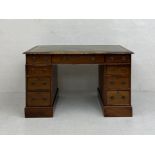 A 19th century mahogany twin pedestal desk in three parts having a gilt and tooled green leather top