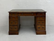 A 19th century mahogany twin pedestal desk in three parts having a gilt and tooled green leather top