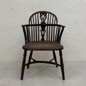 A 19th century elm and yew Windsor armchair having a shaped and spindled back with openwork splat