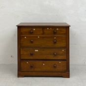 A 19th century walnut chest of two short over three long graduating drawers with turned handles