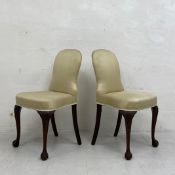 A pair of Georgian style dining chairs each having a shaped cushioned back and satin upholstered