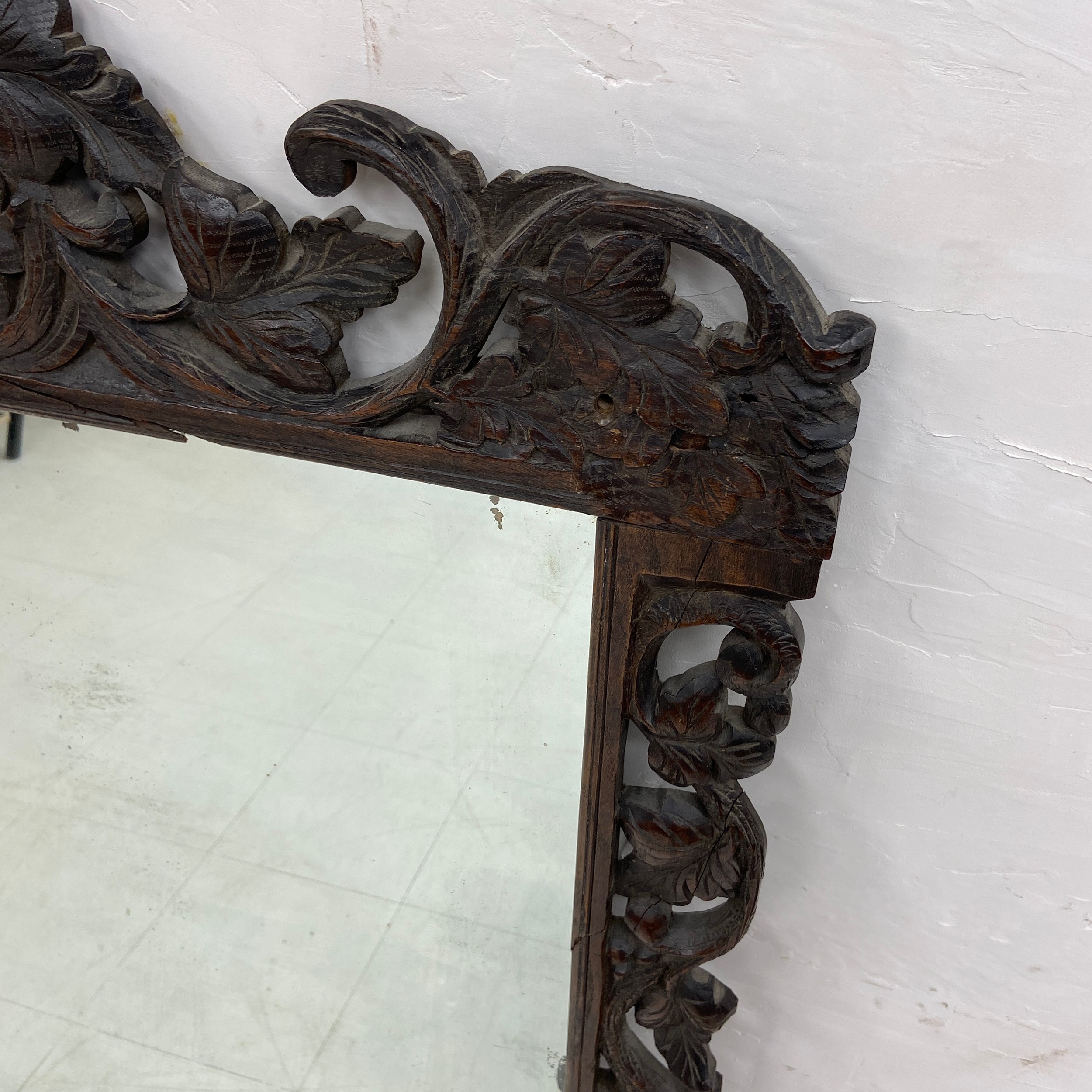 A large 19th century overmantle mirror having a rectangular plate in an ornately carved Baroque - Image 2 of 4