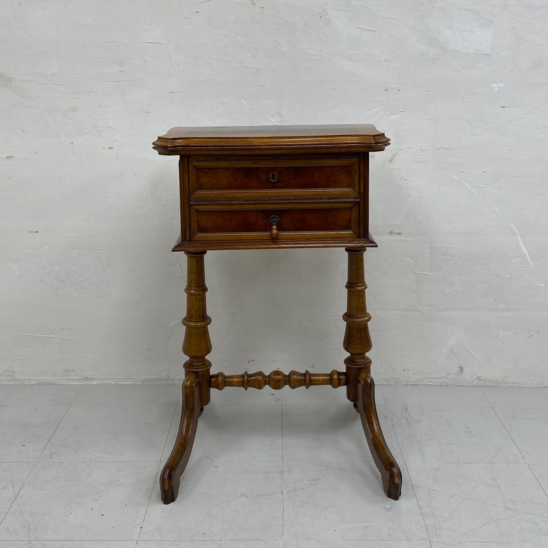 A 19th century Continental walnut side or work table having a book-matched and crossbanded revolving