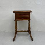 A 19th century Continental walnut side or work table having a book-matched and crossbanded revolving