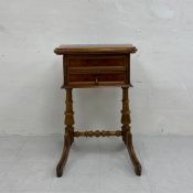 A 19th century Continental walnut side or work table having a book-matched and crossbanded revolving